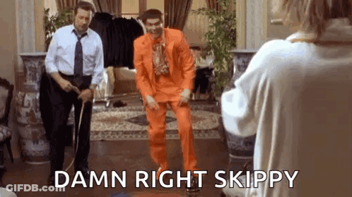 Man In Orange Suit Dancing In Front Of Woman GIF