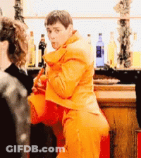 Man In Orange Suit Dancing GIF