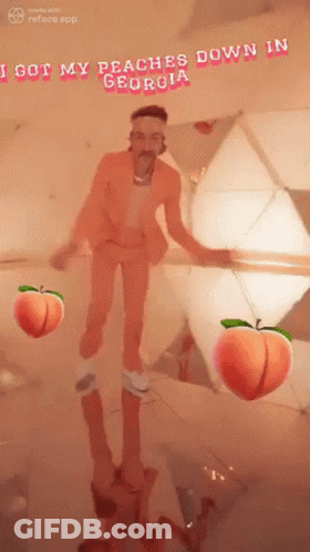 Man In Orange Suit In Front Of Mirror With Peaches GIF