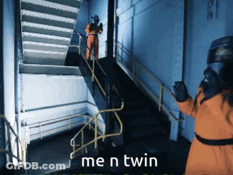 Man In Orange Suit Standing On Stairs GIF