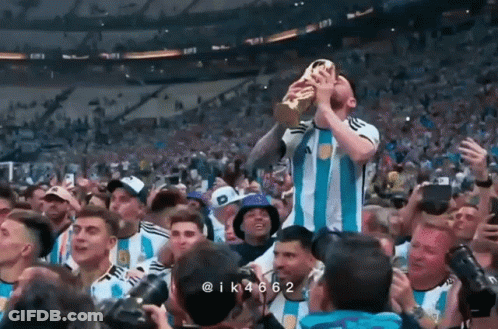 Man In Orange Suit With Longhorn In Crowd GIF