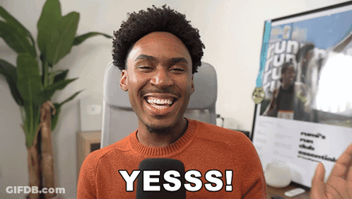 Man In Orange Sweater Saying Yesss GIF