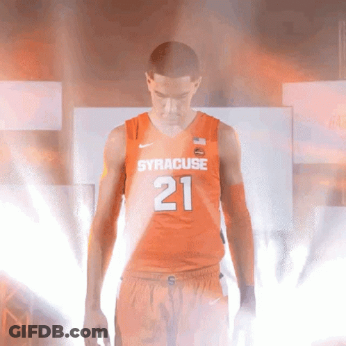 Man In Orange Syracuse Jersey In Dim Room GIF