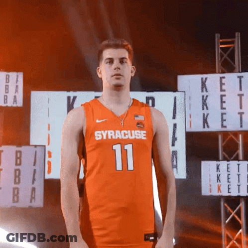 Man In Orange Syracuse Jersey Standing Before Scoreboard GIF