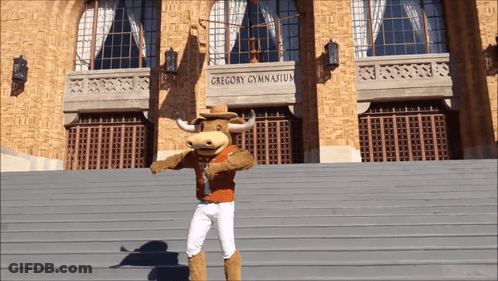 Man In Orange Texas Shirt Giving Peace Sign GIF
