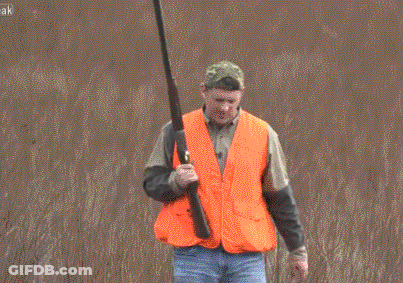 Man In Orange Vest Holding Gun GIF
