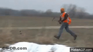 Man In Orange Vest Running In Field GIF