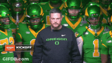 Man In Oregon Shirt In Front Of Football Team GIF