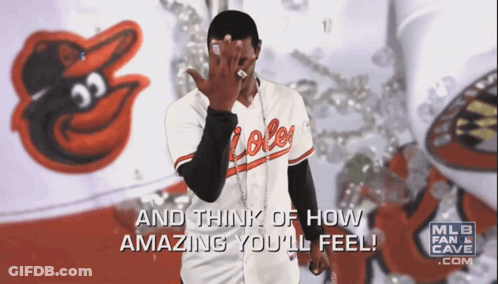 Man In Orioles Jersey Covering Face GIF