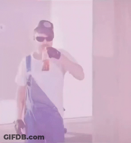 Man In Overalls And Blue Hat Holding Sword In Mouth GIF