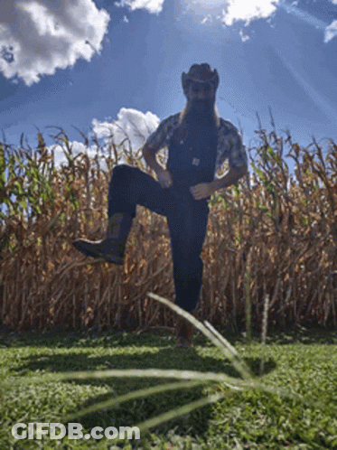 Man In Overalls And Cowboy Hat In Cornfield GIF