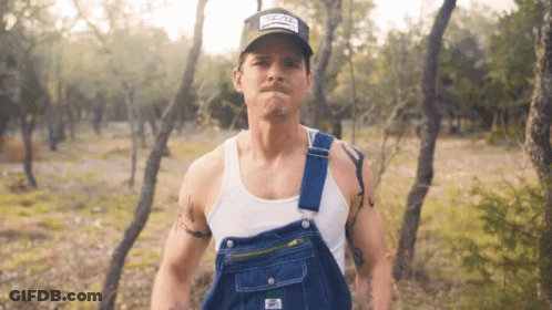 Man In Overalls And Hat With Texas Patch GIF