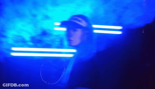 Man In Overalls And Mask In Crowd With VT Hats GIF