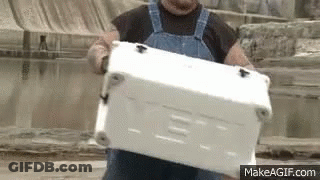 Man In Overalls Carrying White Cooler GIF
