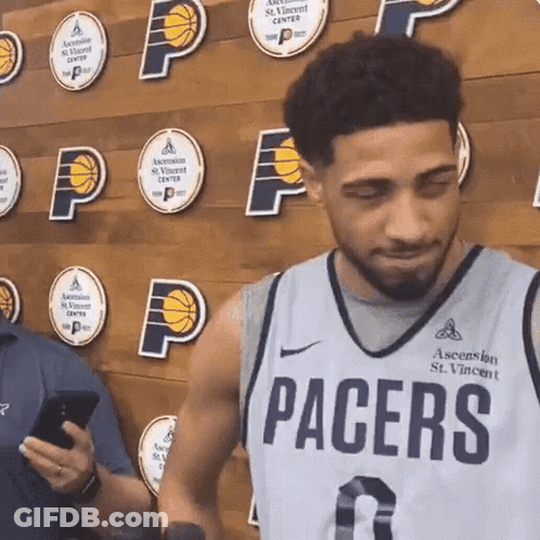 Man In Pacers Jersey Looking At Phone GIF