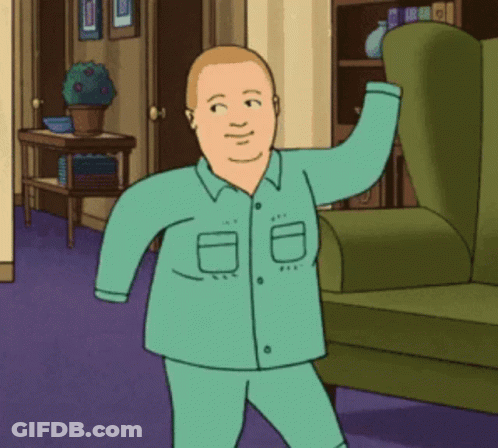 Man In Pajamas Standing Next To Green Chair GIF