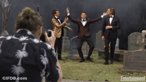 Man In Palm Tree Shirt Photographs Three Tuxedo Men At Cemetery GIF