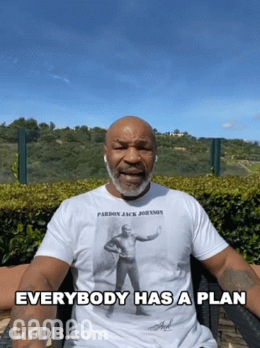 Man In Pardon Jack Johnson T-Shirt Says Everybody Has A Plan GIF