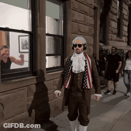Man In Patriotic Costume Walking Down Sidewalk GIF