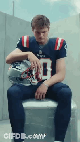 Man In Patriots Jersey On Cooler With Helmet GIF
