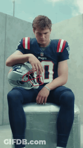 Man In Patriots Jersey With Helmet On Lap GIF