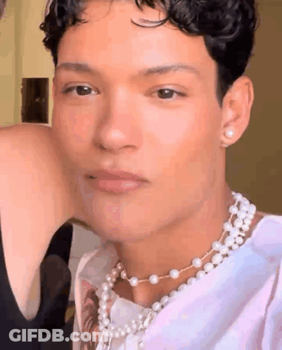 Man In Pearl Necklace And Earrings GIF