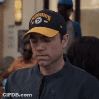 Man In Penguins Baseball Cap Looking Down GIF