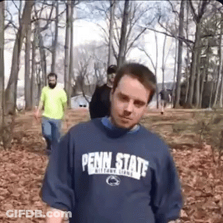 Man In Penn State Shirt Walking Through Forest GIF