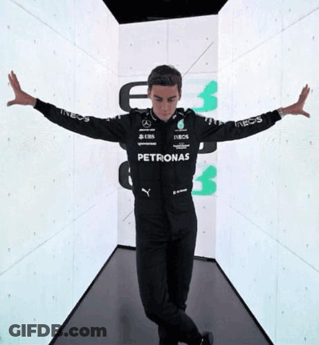 Man In Petronas Jacket In Hallway GIF