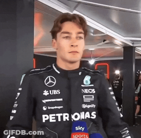 Man In Petronas Jacket With Microphone GIF