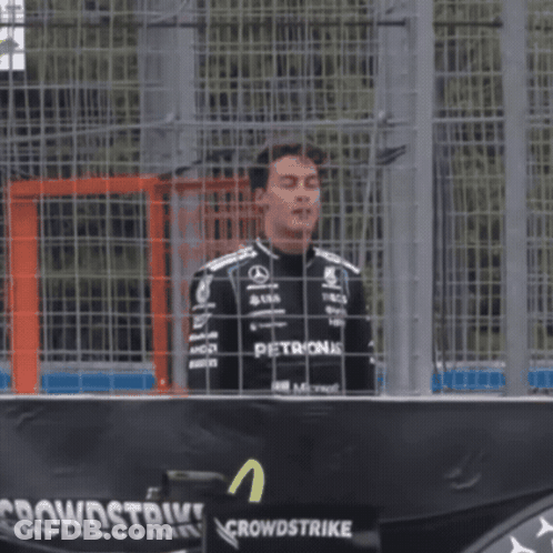 Man In Petronas Shirt At Crowdstrike Sign GIF