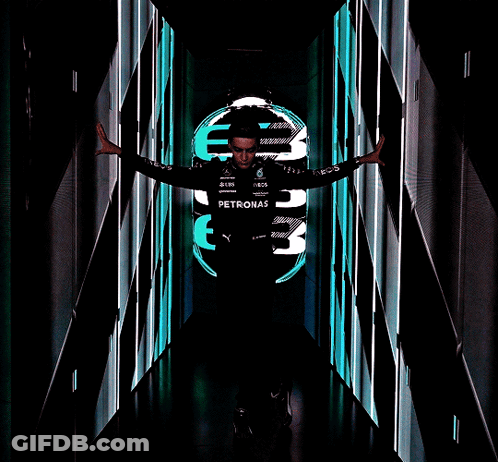 Man In Petronas Shirt In Dark Hallway GIF