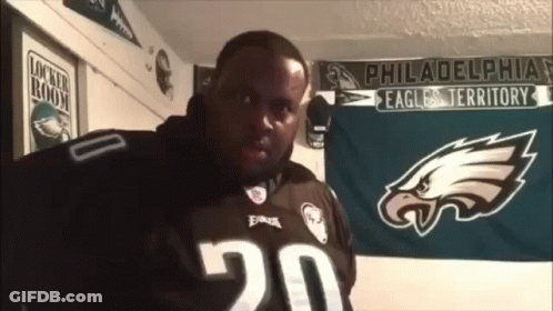 Man In Philadelphia Eagles Jersey In Front Of Banner GIF
