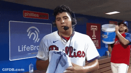Man In Phillies Jersey In Front Of LifeBRC Sign GIF