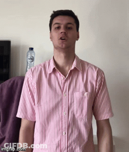 Man In Pink And White Striped Shirt Making Funny Face GIF