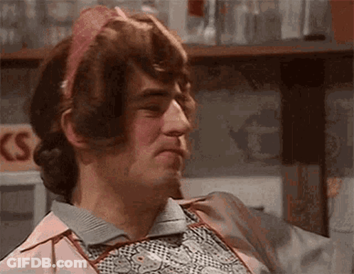 Man In Pink Apron And Headband Making Face GIF