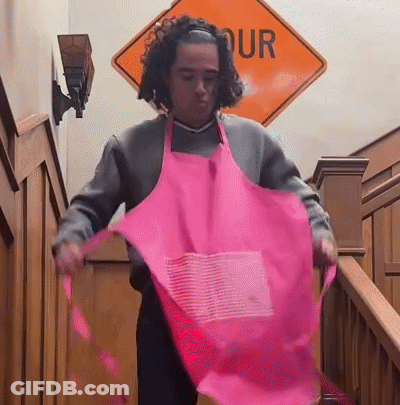 Man In Pink Apron In Front Of Our Sign GIF