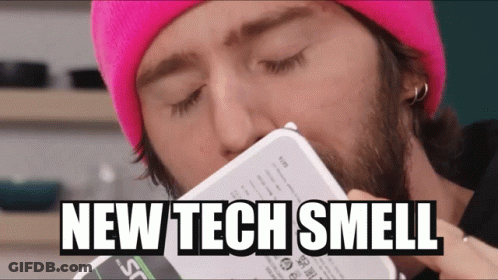 Man In Pink Beanie Smelling Box Saying New Tech Smell GIF