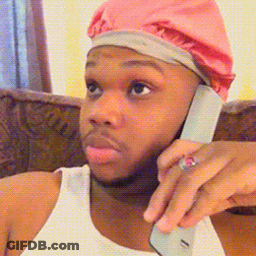 Man In Pink Beanie Talking On Cell Phone GIF