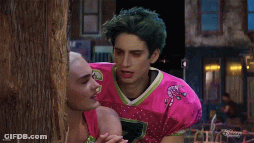 Man In Pink Candy Cane Jersey With Woman GIF