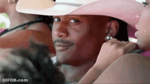 Man In Pink Cowboy Hat Sitting With Woman In Pink Dress GIF