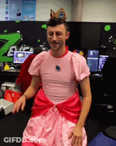 Man In Pink Dress And Crown Standing GIF