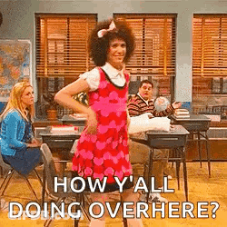 Man In Pink Dress Dancing In Classroom While Woman Sits At Desk GIF