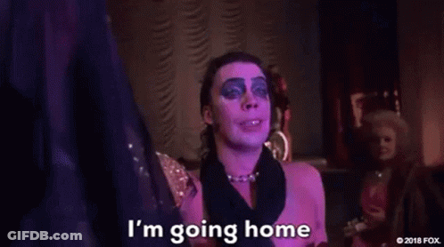 Man In Pink Dress Holding Cake Smiling GIF
