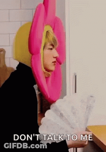 Man In Pink Flower Hat Holding Fan GIF