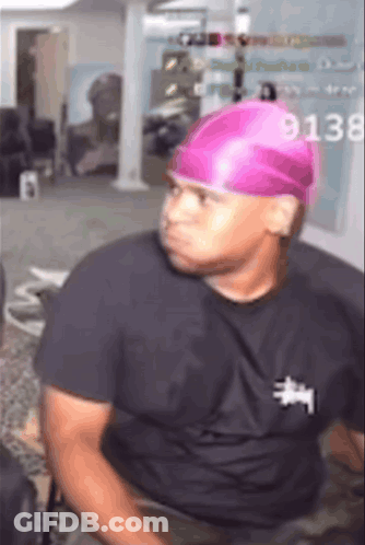 Man In Pink Hat And Black Shirt With 9138 GIF