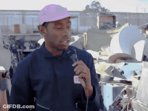 Man In Pink Hat And T-Mobile Jacket Holding Microphone GIF