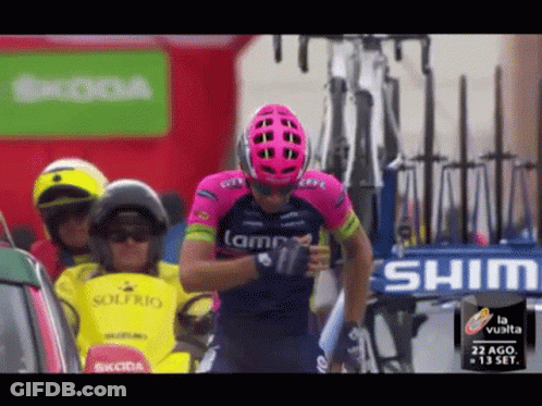 Man In Pink Helmet Standing In Front Of Shima Sign GIF