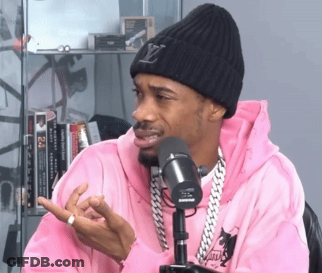 Man In Pink Hoodie And Louis Vuitton Beanie Talking Into Shure Microphone GIF
