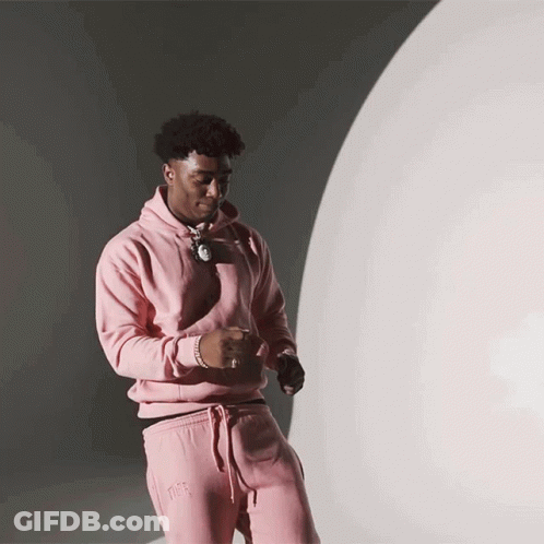 Man In Pink Hoodie And Pink Sweatpants Near White Sphere GIF